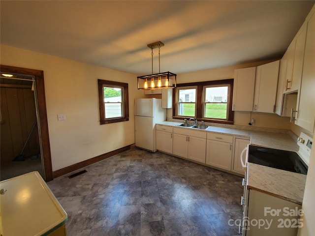 3558 Sunset Grill St, Connelly Springs, NC 28612 - kitchen featuring white appliances, white cabinets, light countertops, and pendant lighting