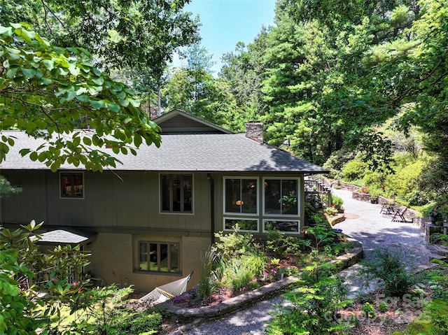 23 Indigo Way, Hendersonville, NC 28739 - view of front of house featuring roof with shingles and a chimney