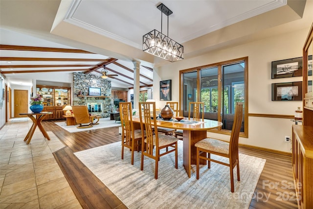 23 Indigo Way, Hendersonville, NC 28739 - dining area featuring a stone fireplace, ceiling fan, ornate columns, crown molding, and light wood finished floors