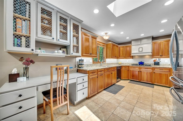 23 Indigo Way, Hendersonville, NC 28739 - kitchen with custom range hood, a skylight, gas stovetop, brown cabinets, and light stone counters