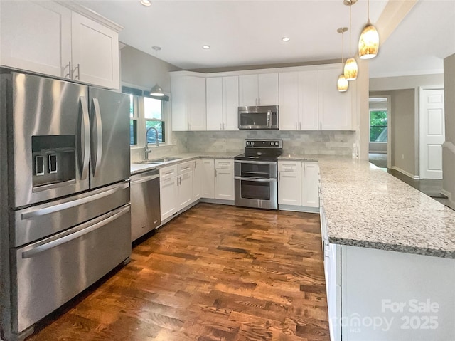 27 Quayside Ct, Clover, SC 29710 - kitchen with stainless steel appliances, a peninsula, plenty of natural light, decorative backsplash, and recessed lighting