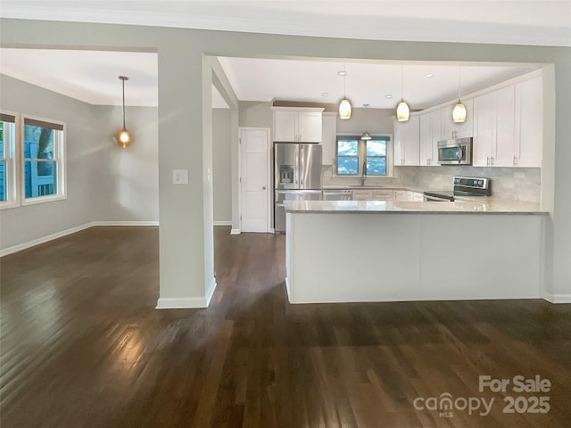27 Quayside Ct, Clover, SC 29710 - kitchen with appliances with stainless steel finishes, dark wood-type flooring, white cabinets, tasteful backsplash, and a peninsula