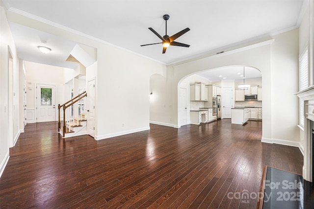 646 Quicksilver Trl Unit 183, Fort Mill, SC 29708 - unfurnished living room featuring ceiling fan, dark wood-style floors, arched walkways, stairway, and crown molding