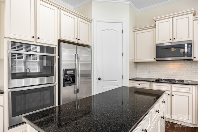 646 Quicksilver Trl Unit 183, Fort Mill, SC 29708 - kitchen with appliances with stainless steel finishes, ornamental molding, tasteful backsplash, dark stone countertops, and cream cabinets