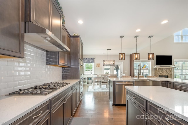 2960 Haley Cir, Davidson, NC 28036 - kitchen with appliances with stainless steel finishes, plenty of natural light, decorative backsplash, dark brown cabinetry, and recessed lighting