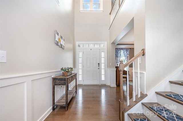 2960 Haley Cir, Davidson, NC 28036 - foyer featuring stairs, a high ceiling, hardwood / wood-style flooring, a wainscoted wall, and a decorative wall