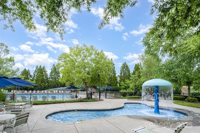 2960 Haley Cir, Davidson, NC 28036 - community pool featuring a patio area and view of wooded area