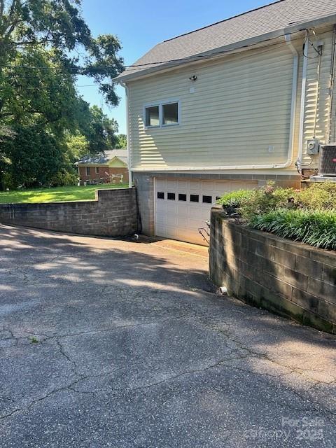 743 S College Ave, Newton, NC 28658 - view of side of property featuring an attached garage, driveway, and roof with shingles