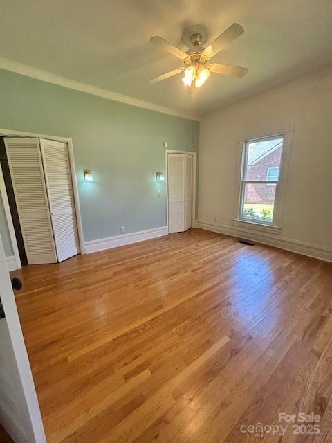 743 S College Ave, Newton, NC 28658 - unfurnished bedroom featuring light wood finished floors, ornamental molding, and a ceiling fan
