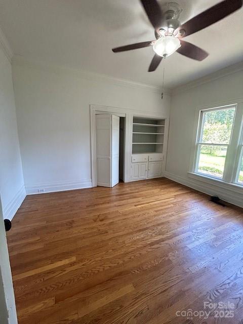 743 S College Ave, Newton, NC 28658 - unfurnished bedroom with crown molding, wood finished floors, ceiling fan, and a closet