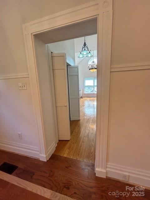 743 S College Ave, Newton, NC 28658 - corridor featuring a chandelier and light wood-style floors