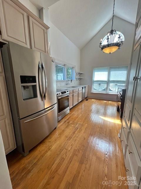743 S College Ave, Newton, NC 28658 - kitchen featuring appliances with stainless steel finishes, light wood finished floors, high vaulted ceiling, a chandelier, and light countertops