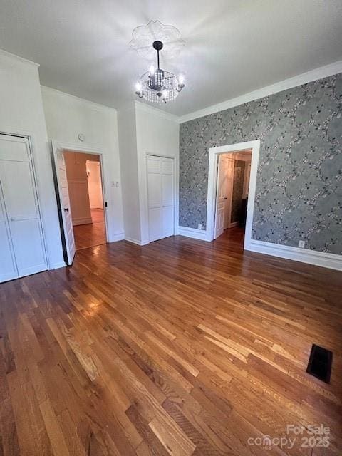 743 S College Ave, Newton, NC 28658 - spare room with a chandelier, crown molding, wallpapered walls, and wood finished floors