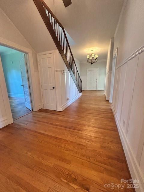 743 S College Ave, Newton, NC 28658 - hall featuring light wood-style floors, a decorative wall, a chandelier, stairway, and ornamental molding