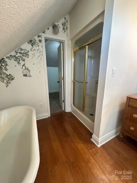 743 S College Ave, Newton, NC 28658 - bathroom with wood finished floors, a shower stall, a soaking tub, a textured ceiling, and vanity