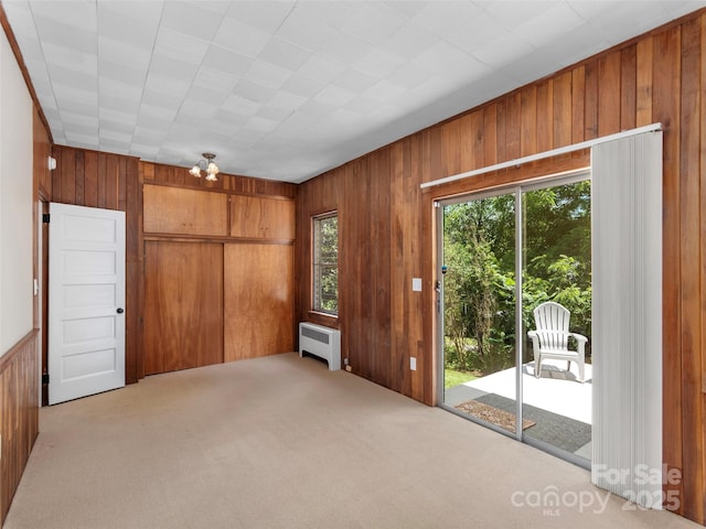 50 Skyland Ter, Canton, NC 28716 - unfurnished bedroom featuring radiator, wooden walls, access to exterior, carpet flooring, and a closet