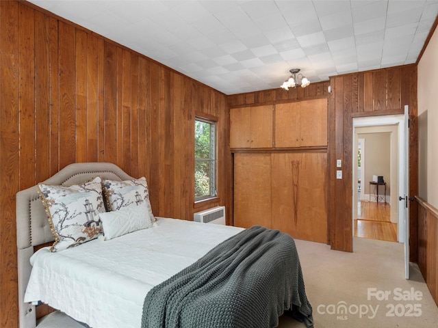 50 Skyland Ter, Canton, NC 28716 - bedroom with wood walls, radiator heating unit, a closet, carpet, and a chandelier