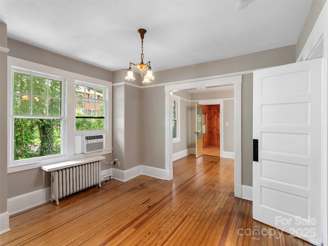 50 Skyland Ter, Canton, NC 28716 - empty room with radiator, light wood-style flooring, a chandelier, and cooling unit