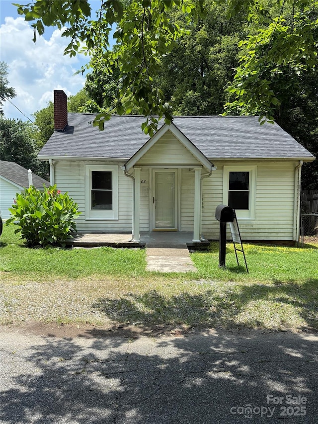 1008 Packard Ave, Kannapolis, NC 28083 - bungalow featuring a chimney, a shingled roof, and a front lawn