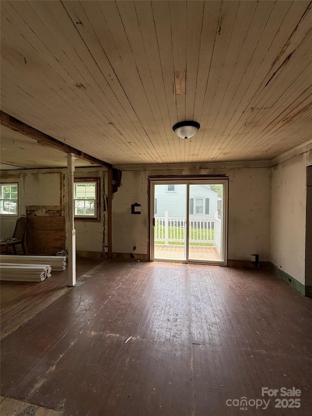 1008 Packard Ave, Kannapolis, NC 28083 - unfurnished living room featuring wooden ceiling, plenty of natural light, and hardwood / wood-style flooring
