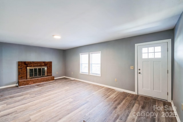 1229 Jenkins St, Rock Hill, SC 29732 - unfurnished living room with healthy amount of natural light, wood finished floors, and a brick fireplace