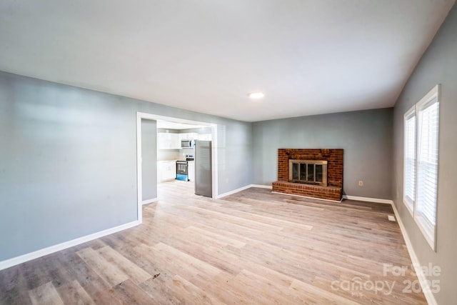 1229 Jenkins St, Rock Hill, SC 29732 - unfurnished living room with a brick fireplace and light wood finished floors