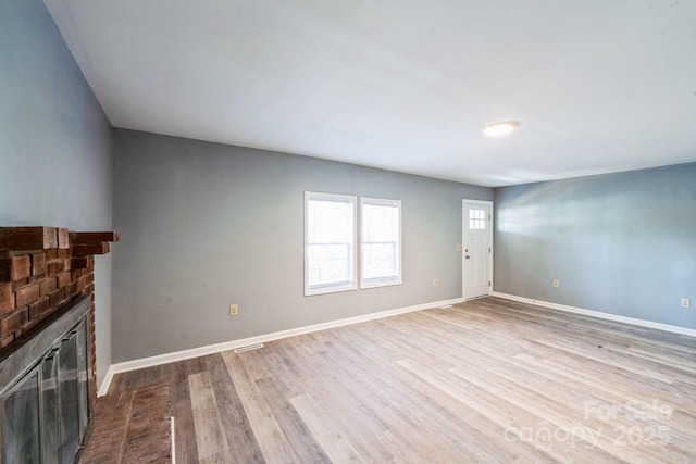 1229 Jenkins St, Rock Hill, SC 29732 - unfurnished living room with a brick fireplace and dark wood-type flooring