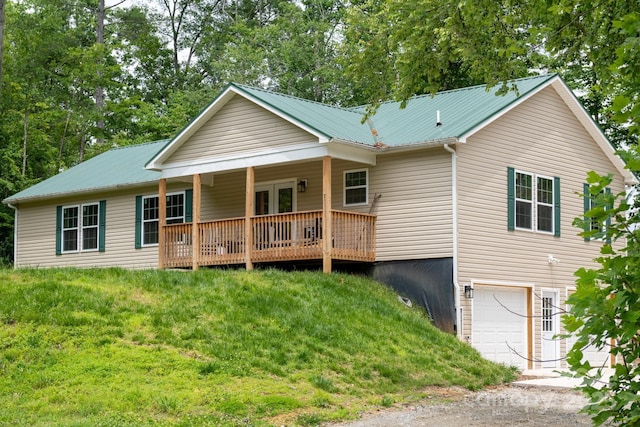 1036 Williamsburg Dr, Lenoir, NC 28645 - back of property with a garage, a metal roof, driveway, a yard, and covered porch