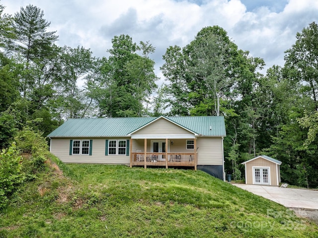 1036 Williamsburg Dr, Lenoir, NC 28645 - single story home featuring french doors, a front yard, a metal roof, and a wooden deck
