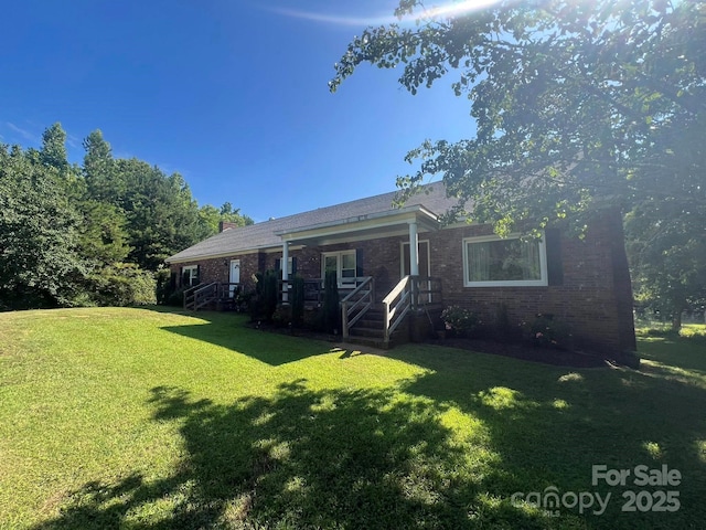 2437 Knox Station Rd, Chester, SC 29706 - rear view of house featuring a lawn, brick siding, and a chimney