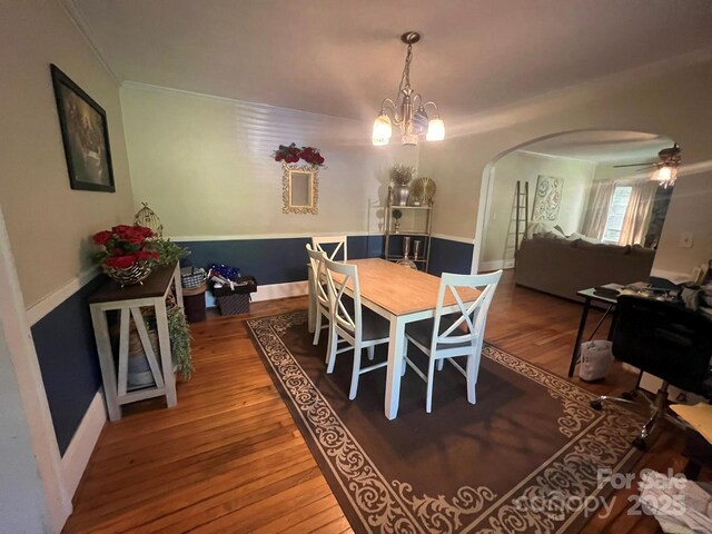 2437 Knox Station Rd, Chester, SC 29706 - dining space featuring arched walkways, wood finished floors, crown molding, a chandelier, and ceiling fan