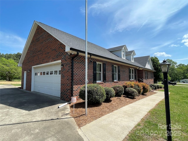 2515 Myra Ln, Lincolnton, NC 28092 - view of side of home with brick siding, driveway, an attached garage, a shingled roof, and a yard