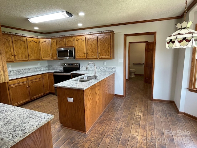 2515 Myra Ln, Lincolnton, NC 28092 - kitchen with stainless steel appliances, brown cabinetry, a textured ceiling, a peninsula, and dark wood finished floors
