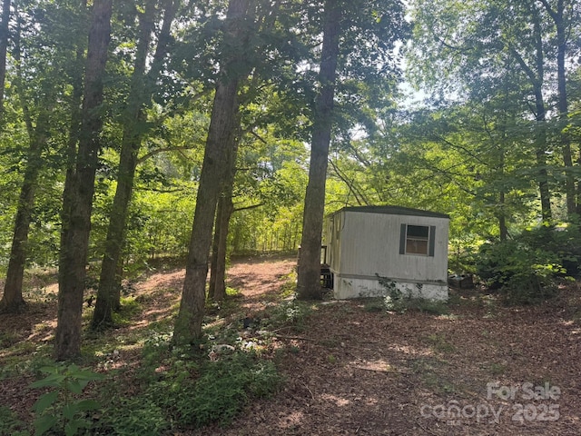 1290 Gardiol Ave NE, Valdese, NC 28690 - view of shed featuring a wooded view