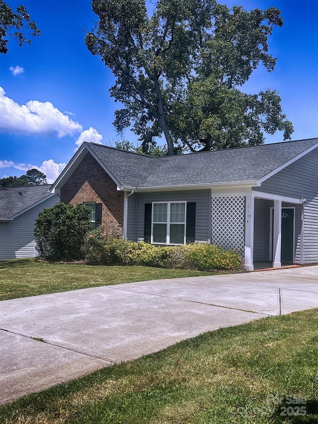 1114 Cason St Unit 6, Belmont, NC 28012 - view of front facade featuring a front lawn, driveway, a shingled roof, and brick siding