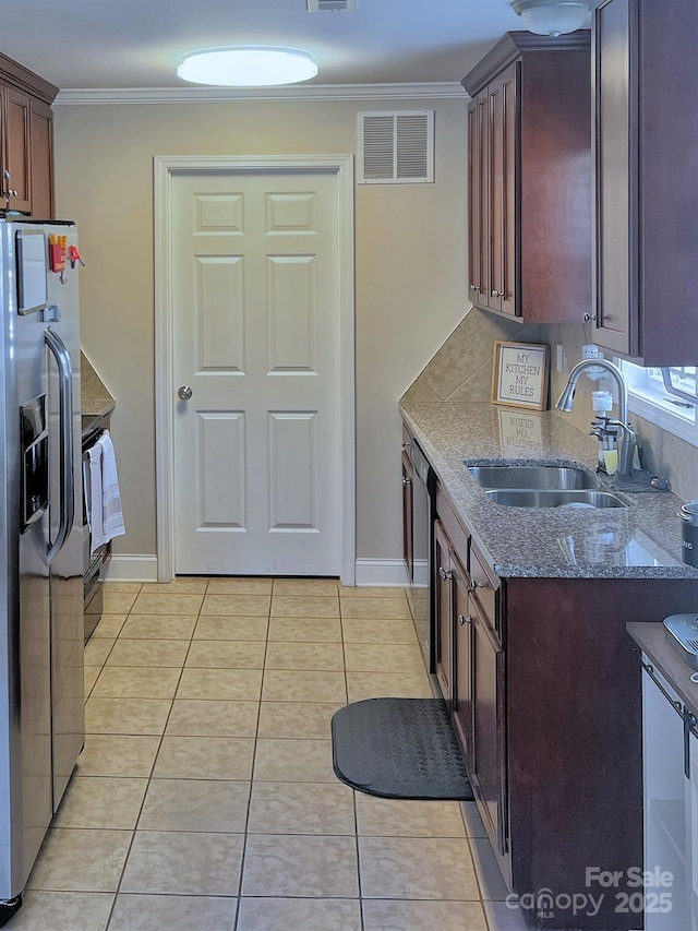 1114 Cason St Unit 6, Belmont, NC 28012 - kitchen with stainless steel appliances, dark stone countertops, crown molding, light tile patterned floors, and dark brown cabinets