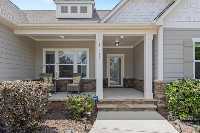 18568 Mainsail Ct, Lancaster, SC 29720 - property entrance with covered porch, a shingled roof, and stone siding