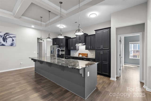18568 Mainsail Ct, Lancaster, SC 29720 - kitchen with a kitchen bar, stainless steel appliances, under cabinet range hood, dark wood-type flooring, and a spacious island