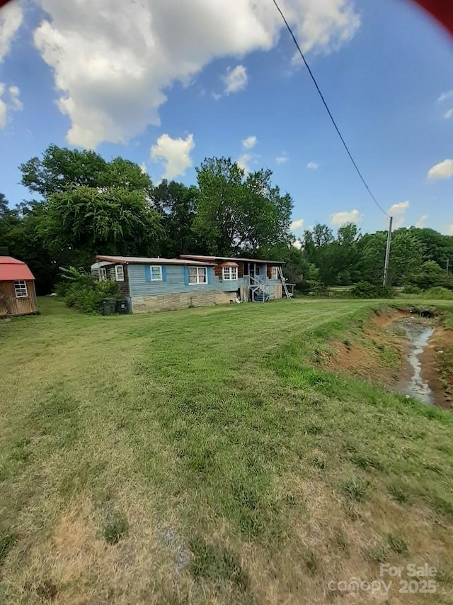 3913 Stough Rd SW, Concord, NC 28027 - rear view of property featuring a yard and a storage shed