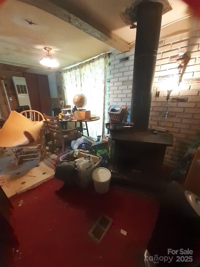 3913 Stough Rd SW, Concord, NC 28027 - dining area featuring a wood stove and brick wall