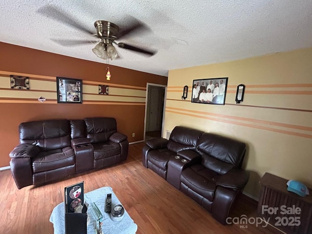 407 Alton St, Monroe, NC 28110 - living room featuring a ceiling fan, wood finished floors, and a textured ceiling