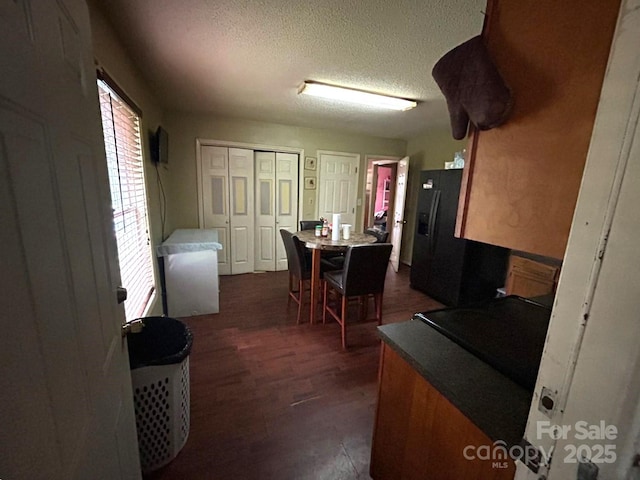 407 Alton St, Monroe, NC 28110 - dining space with a textured ceiling and dark wood-type flooring
