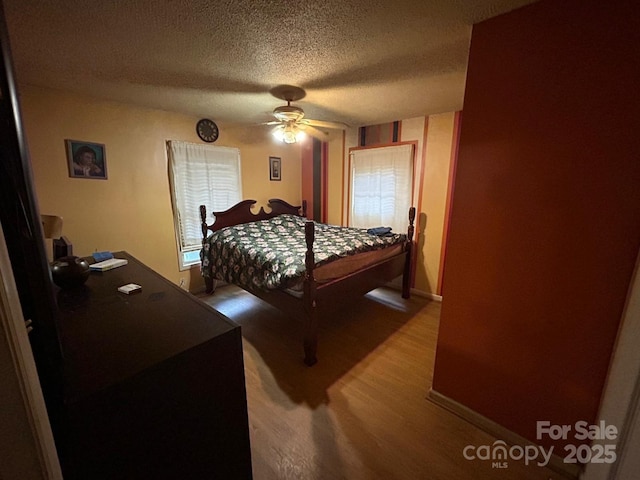 407 Alton St, Monroe, NC 28110 - bedroom featuring wood finished floors, a textured ceiling, and ceiling fan
