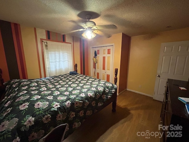 407 Alton St, Monroe, NC 28110 - bedroom with light wood finished floors, a textured ceiling, a closet, and a ceiling fan