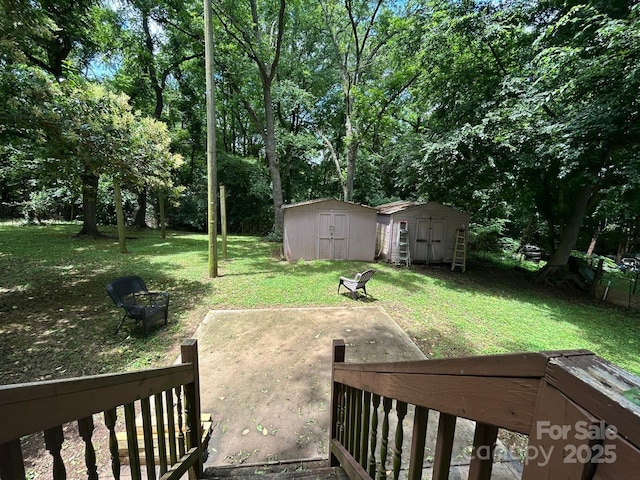 407 Alton St, Monroe, NC 28110 - view of grassy yard featuring a shed and a patio area