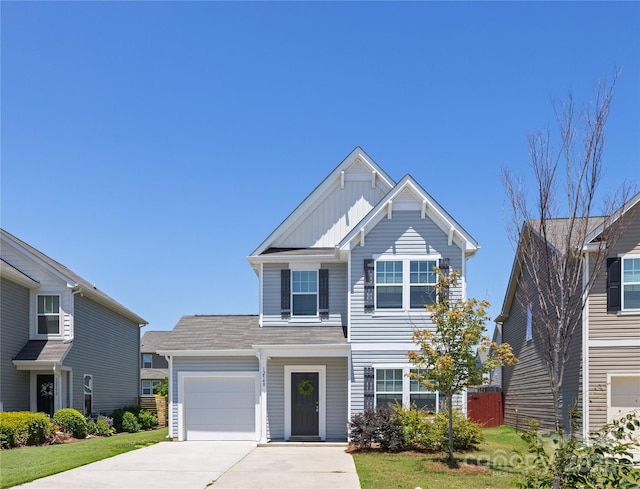 12548 Gotland Rd Unit 327, Midland, NC 28107 - view of front facade with concrete driveway, an attached garage, and board and batten siding
