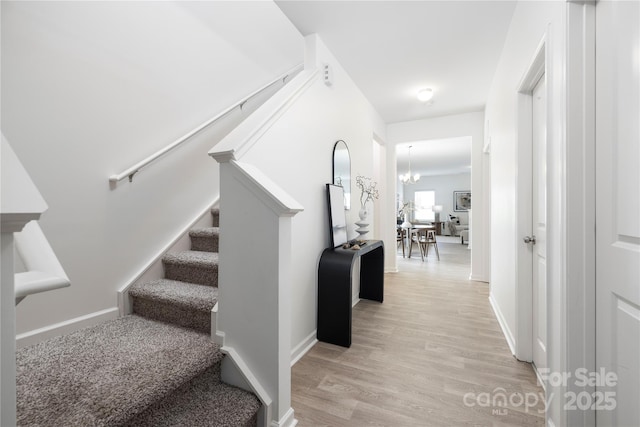12548 Gotland Rd Unit 327, Midland, NC 28107 - staircase featuring wood finished floors and a chandelier