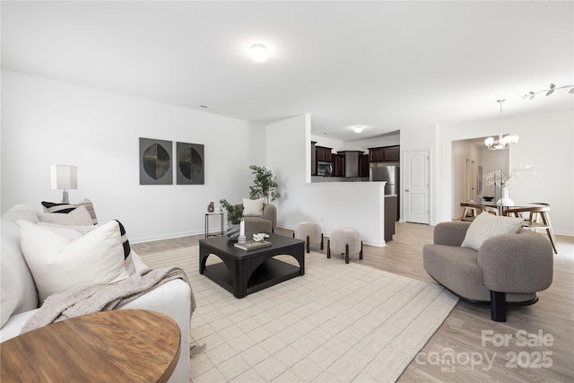 12548 Gotland Rd Unit 327, Midland, NC 28107 - living area featuring a chandelier and light wood-style floors