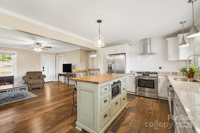 268 Oakland Rd, Spindale, NC 28160 - kitchen with stainless steel appliances, wall chimney range hood, butcher block countertops, a breakfast bar area, and open floor plan