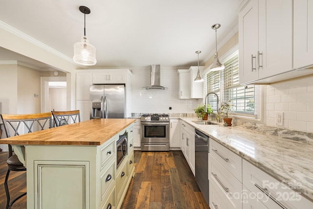 268 Oakland Rd, Spindale, NC 28160 - kitchen featuring stainless steel appliances, wood counters, wall chimney range hood, a breakfast bar, and tasteful backsplash